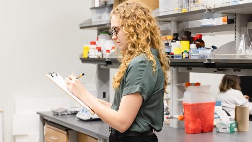student taking notes in a laboratory